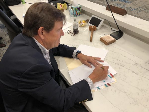 Macon Water Authority Chairman Gary Bechtel signs a supplemental bond resolution Thursday to fund $113 million in capital improvement projects for the utility. 