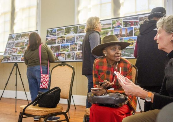 Angel Irving, second from right, talks with Atlanta landscape architect and planner Lauren Standish, right, during a community meeting Thursday about the proposed East Bank redevelopment project at the old Bibb Mill site. Irving said as the project goes forward, she wants assurances that on site jobs are open to local workers.