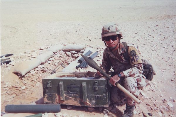 Michael Junod crouches next to a bunker complex in Iraq in 1991. Photo courtesy Michael Junod