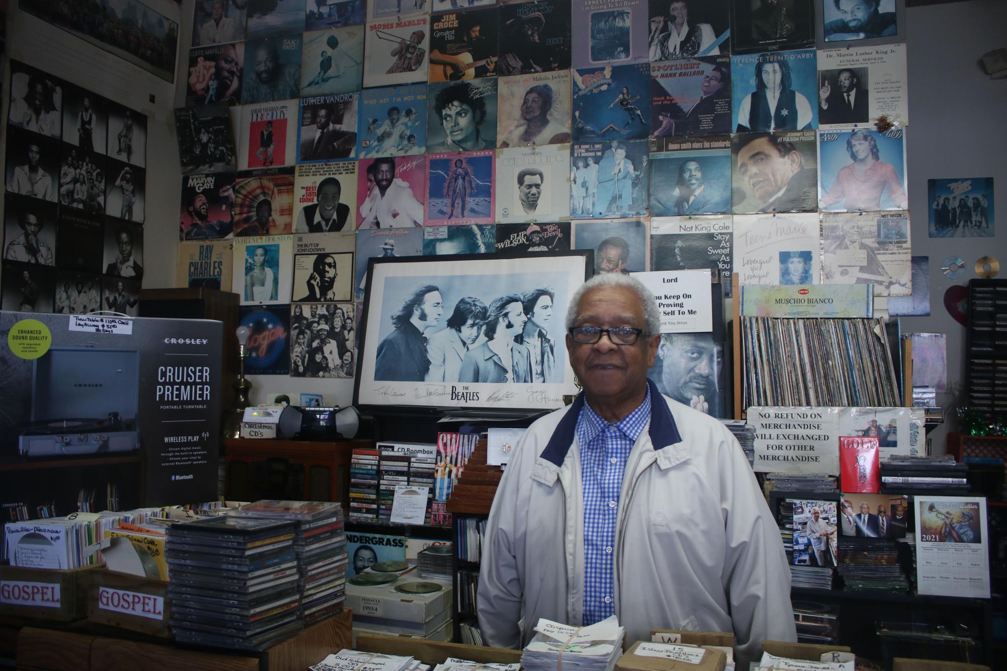 Lafayette Haynes smiles behind the counter of his record shop, Old School Music Headquarters, on October 22nd, 2024.