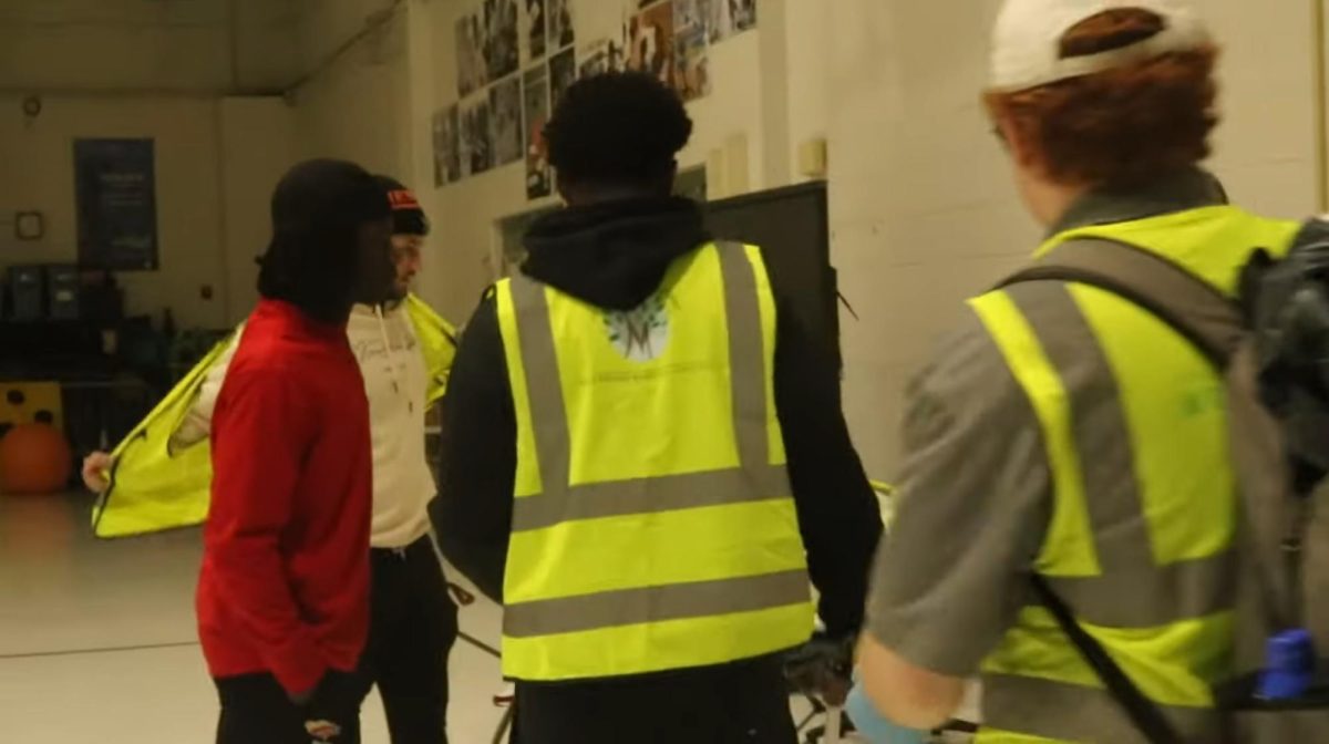 Student volunteers taking their safety vests off after cleaning Burdell-Hunt Magnet School
