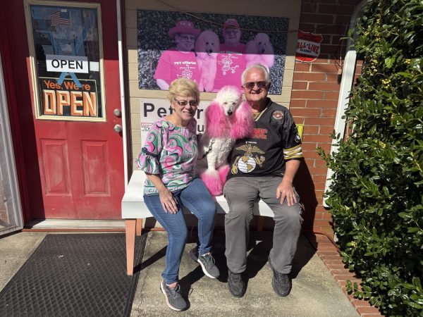 Paul and Alice Williams with Cherry the Pink Poodle outside Pet Grooming by Paul and Alice