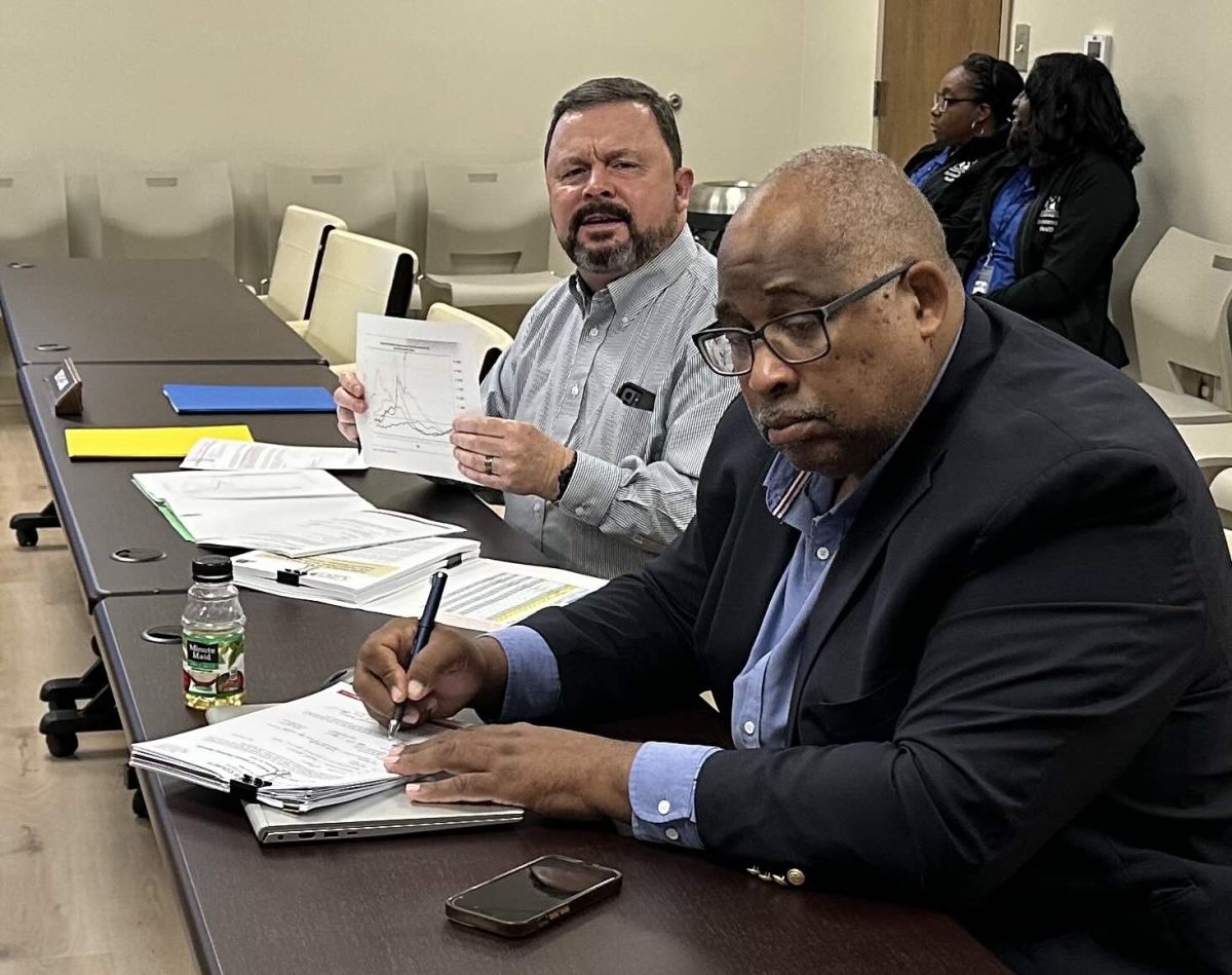 Dr. Thomas Craft, left, shows the Macon-Bibb County Board of Health the sharp spike in flu cases this season, which is the worst in 15 years. 