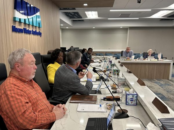 Macon Water Authority Finance Chairman Dwight Jones, center left, discusses purchasing card issues with District 2's Desmond Brown during the March 6 MWA meeting.