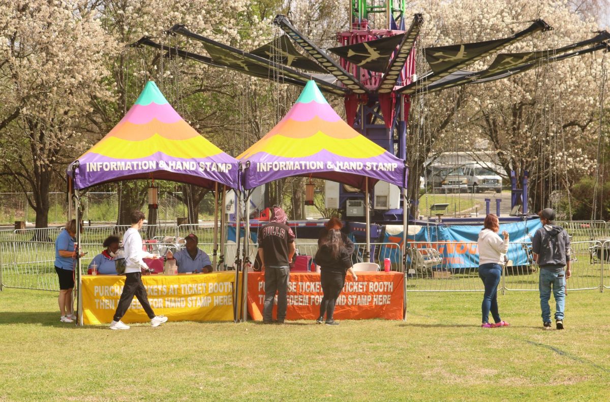 On Sunday, March, 17 2024 at the Macon international Cherry Blossom Festival at Carolyn Cratyon park, visitors go up to the information and hand stamp booth. 