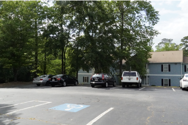 A neighborhood in West Macon featuring well-maintained tree canopies, with trees lining the sidewalks and providing shade and beauty. 