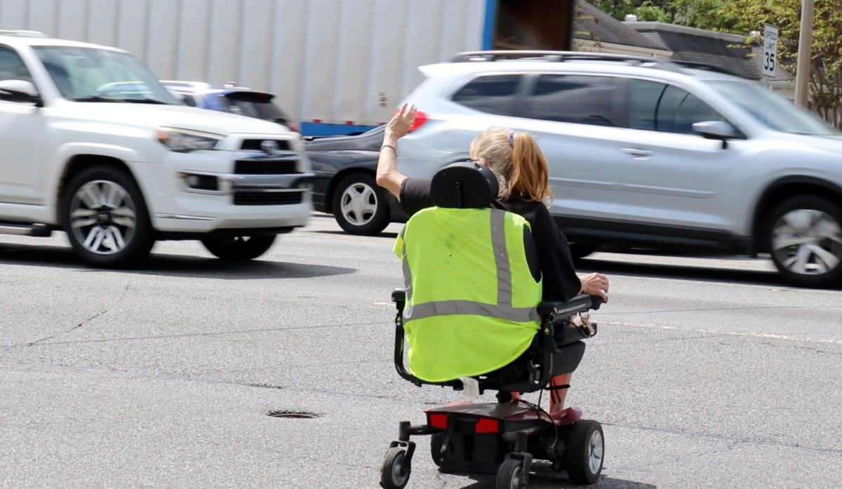A woman crosses Gray Highway in Macon, Ga. (Photo still by Jackson Bramlett) 