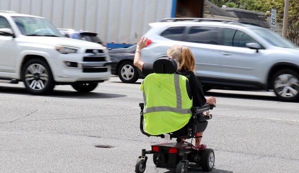 A woman crosses Gray Highway in Macon, Ga. (Photo still by Jackson Bramlett) 