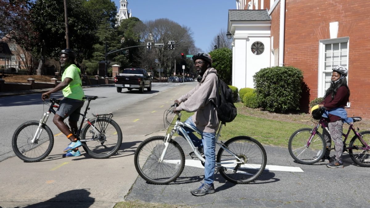 Participants of Recycle Macon prepare to cross the road as part of a bicycle skills class. 