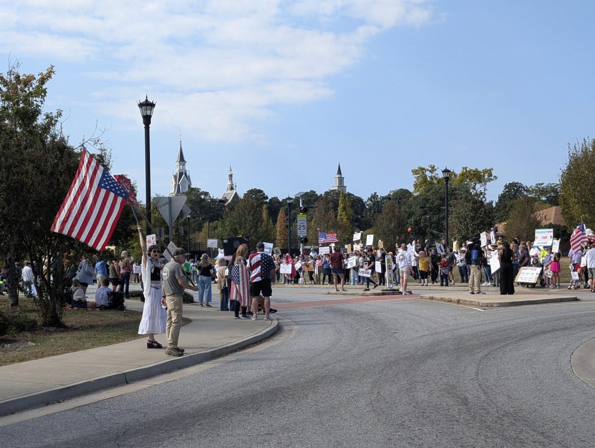 Protesters lined College and Oglethorpe Streets to demonstrate against the Trump administration in Macon on Oct. 18, 2025. 

