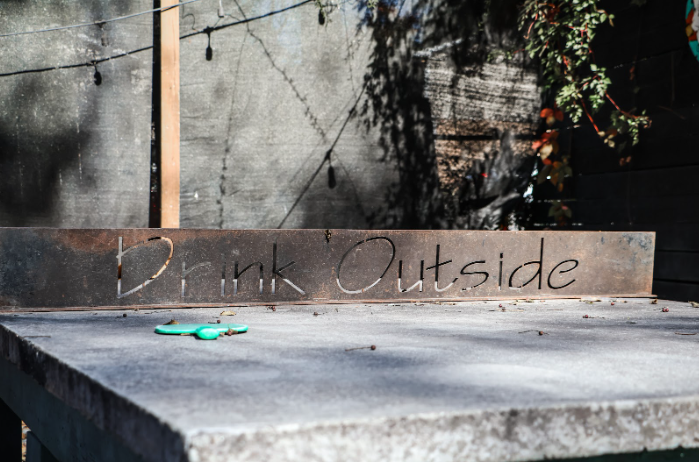 A ping pong table with the words "Drink Outside" is seen at The Society Garden in Macon, Ga. 