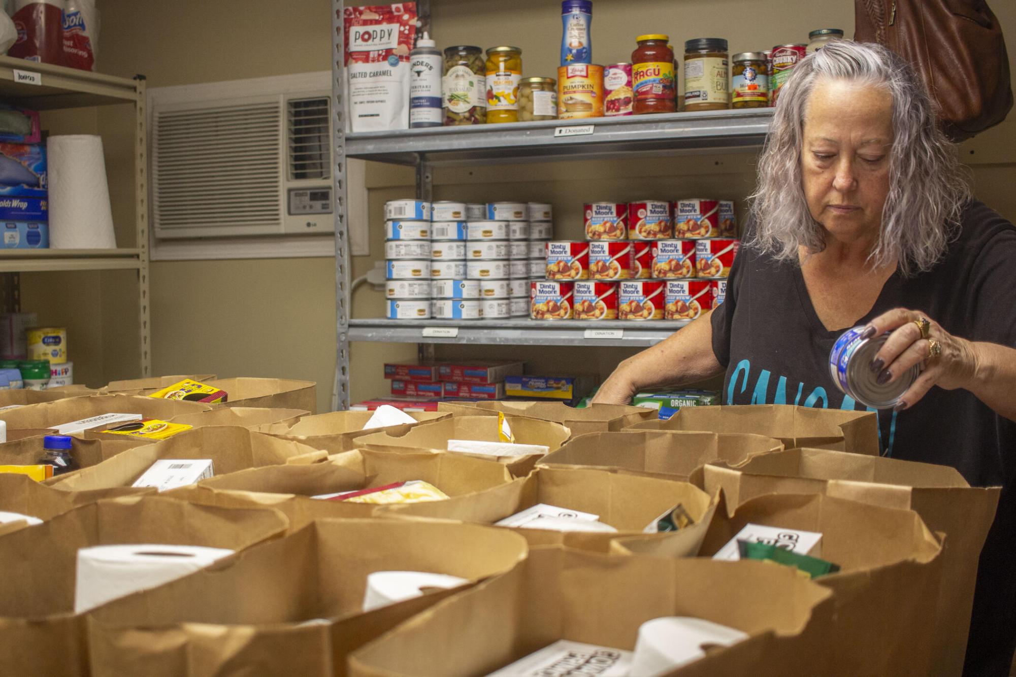 Bernice Jackson organizes supplies into paper bags at the First Baptist Church food pantry in Jefferson, Ga., on Nov. 3, 2025. Each bag is supposed to have a month's worth of food for one person.