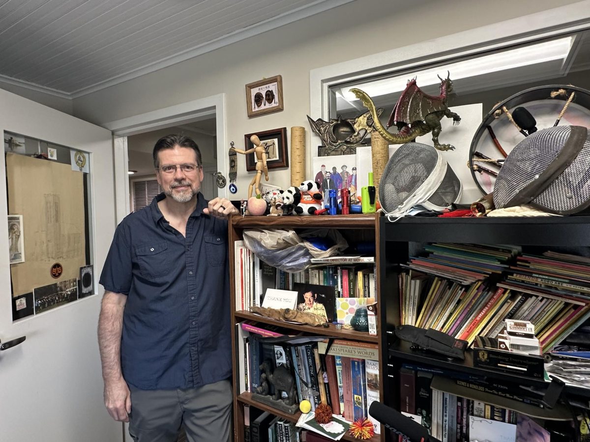 Scot Mann, Professor of Theatre at Mercer University in his office next to his bookshelf after discussing the realities of the professional acting world.