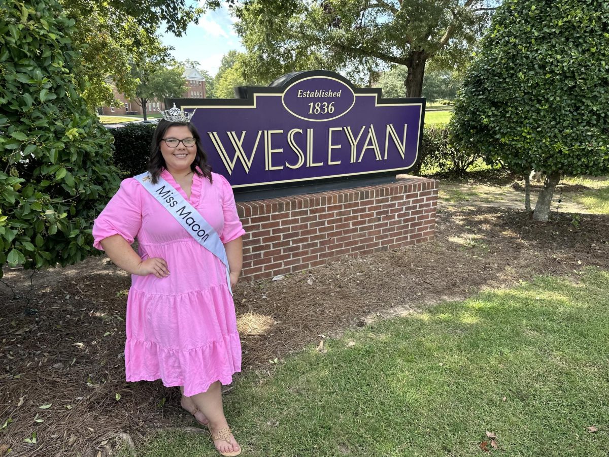 Miss Macon 2026 Shelby Smith poses in front of the entrance sign of Wesleyan College, one of the top scholarship contributors for the Miss Macon pageant. 