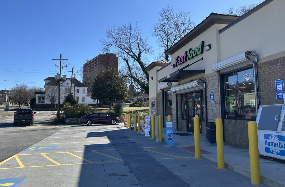A pickup truck exits through an illegal driveway at the Fast food store at 1436 Forsyth St. The owner temporarily lost his zoning compliance because of that driveway and other noncompliance issues.  