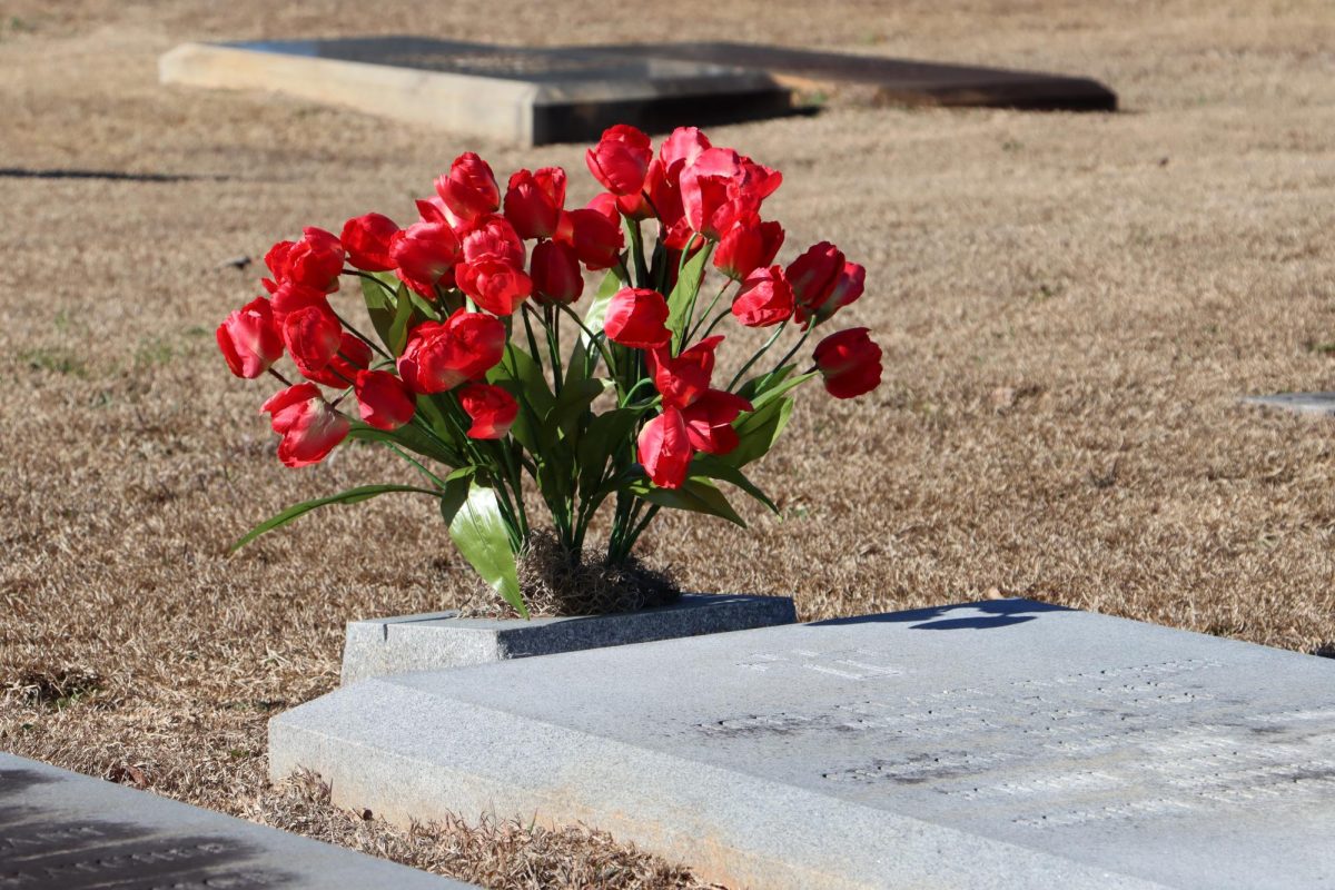 Flowers placed by a grave in Riverside Cemetery, on Friday, Feb. 13, 2026.
