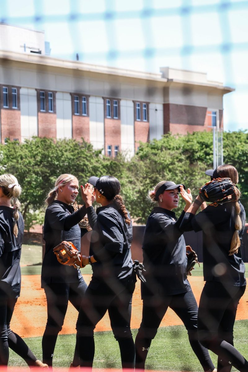 The team lines up for high-fives before taking the field for their game against Furman University on Sunday, April 12, at Sikes Field in Macon, Ga. The Bears won the game, 5-4, breaking the Paladin’s three-game streak. 
