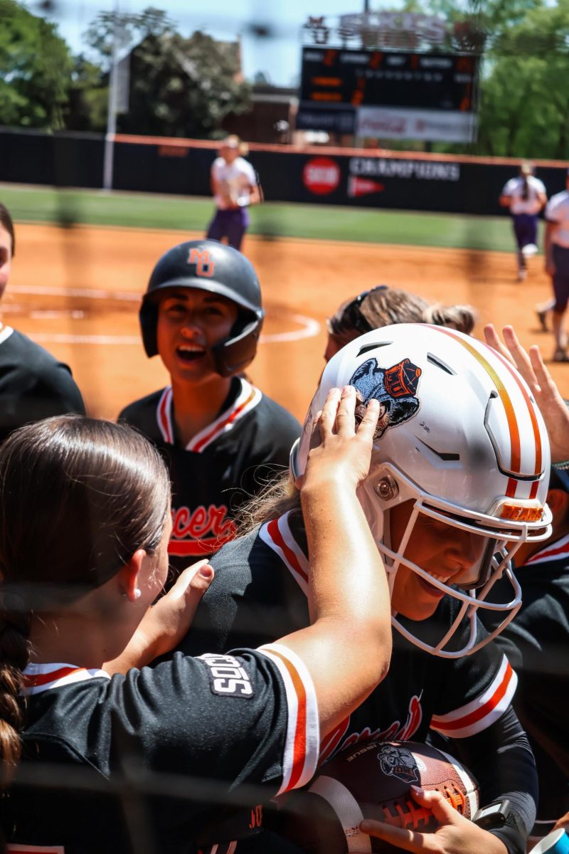 Grace Jones celebrates with her team after scoring her fifth home run of the season in their against Furman University on Sunday, April 12, at Sikes Field in Macon, Ga. The Bears won the game, 5-4, breaking the Paladin’s three-game streak. 
