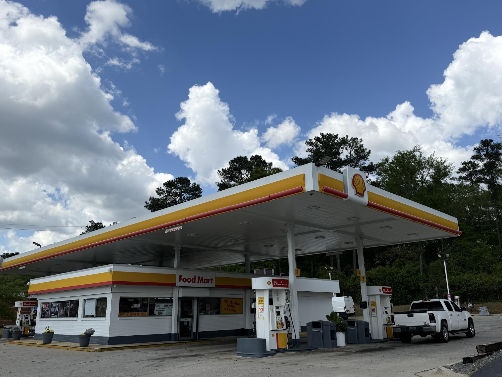 Photograph of shell gas station. One truck seen as the gas pumps. 