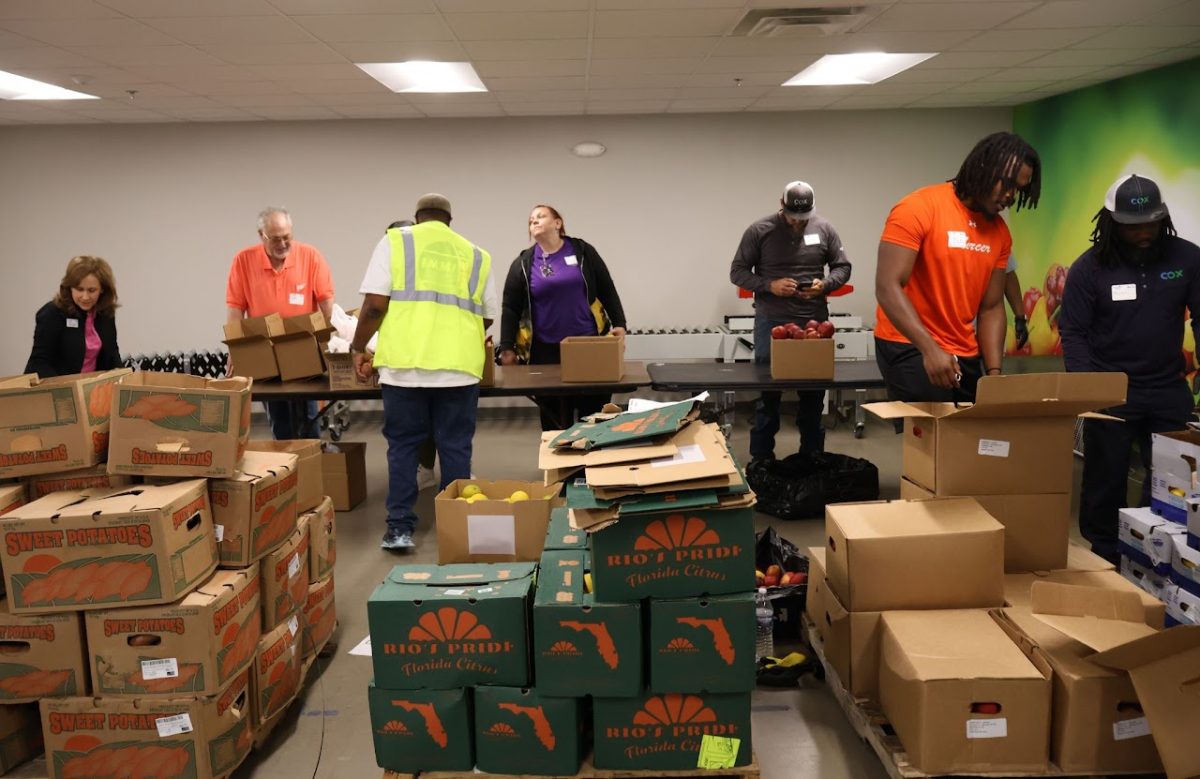 A group of volunteers from IMMI and Mercer University students use the food conveyor to pack food parcels, designed specifically for elderly people in partnership with The Middle Georgia Community Food Bank , on April 15, 2026. 