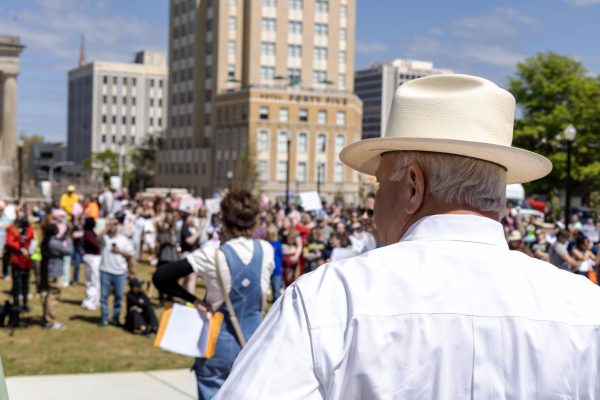 Bibb County Sheriff David Davis looks at a disgruntled crowd during the No Kings protest at Rosa Parks Square in Macon, Ga. Saturday, March 28, 2026. Davis has faced criticism for the Bibb County Jail’s conditions, his department’s 287(g) agreement and a contract with Flock Security.